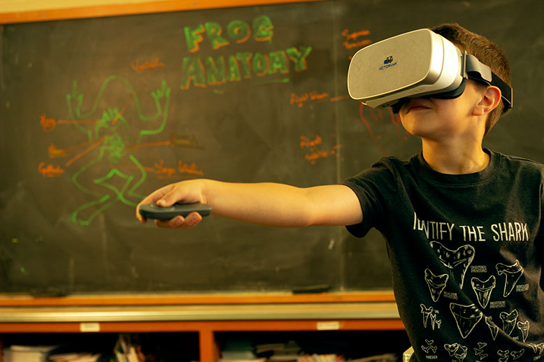 kid using virtual reality goggles in a classroom